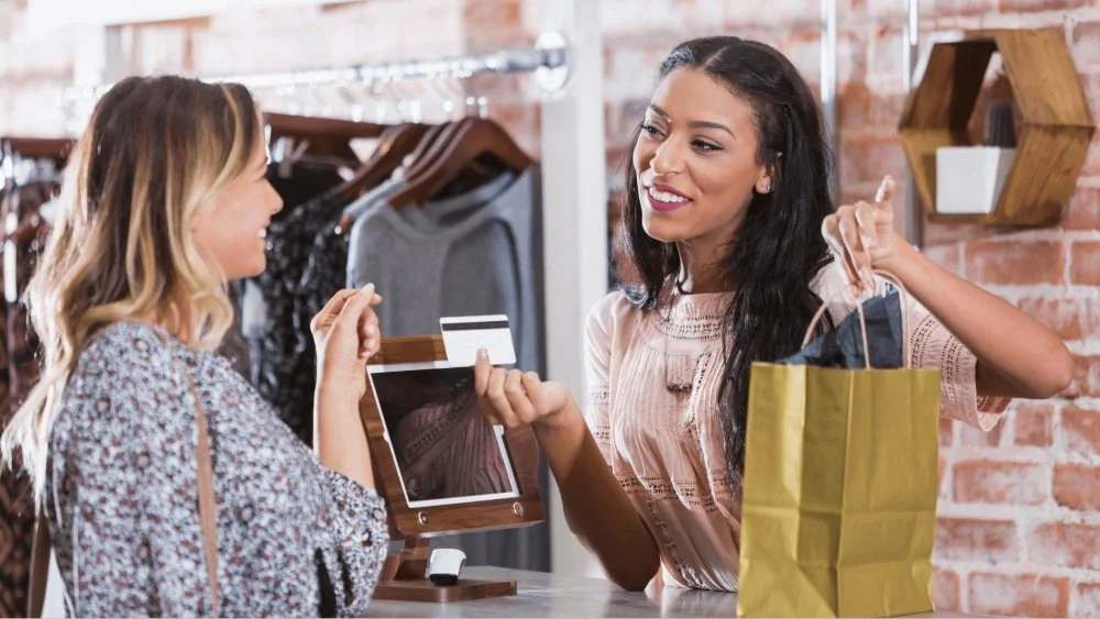 Customer paying at a shop counter on a reliable business network